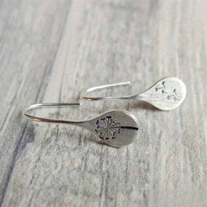 Élégantes boucles d'oreilles design feuille de pissenlit