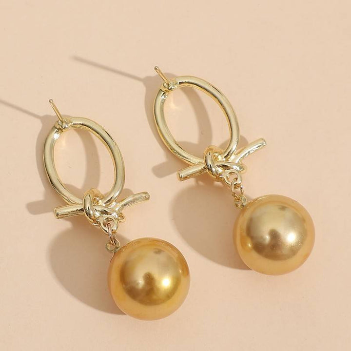 Boucles d’oreilles créoles dorées à perles